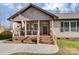 Inviting front porch with a patriotic flag, decorative plants, and comfortable seating at 124 Washington St, York, SC 29745
