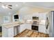 Bright kitchen with stainless steel appliances, sleek white cabinets, and modern design at 124 Washington St, York, SC 29745