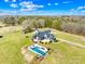 Aerial view showcasing a private pool, outdoor space, and beautifully landscaped grounds at 12613 Oak Grove Rd, Stanfield, NC 28163