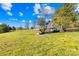 Backyard featuring a custom playhouse structure with a deck, ladder, and slide at 12613 Oak Grove Rd, Stanfield, NC 28163