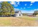 A well-maintained barn with gray siding and a metal roof sits on a manicured lot at 12613 Oak Grove Rd, Stanfield, NC 28163