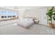 A cozy bedroom with white walls, a plush bed, and built-in storage at 12613 Oak Grove Rd, Stanfield, NC 28163