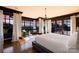 Primary bedroom suite boasts large windows with scenic views, hardwood floors, and sitting area with accent chairs at 12613 Oak Grove Rd, Stanfield, NC 28163