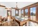 Bright game room boasts a billiard table, hardwood floors and large windows at 12613 Oak Grove Rd, Stanfield, NC 28163