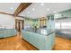 Spacious kitchen featuring green cabinetry, stainless appliances, a large island, and hardwood floors at 12613 Oak Grove Rd, Stanfield, NC 28163