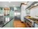 Charming kitchen with green cabinets, stainless steel appliances, and hardwood floors at 12613 Oak Grove Rd, Stanfield, NC 28163