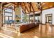 Expansive living room with vaulted ceilings, stone fireplace, grand piano, and hardwood floors at 12613 Oak Grove Rd, Stanfield, NC 28163