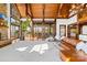 Bright living room with vaulted wooden ceilings, a stone fireplace, large windows, and hardwood floors at 12613 Oak Grove Rd, Stanfield, NC 28163