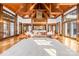 Spacious living room featuring exposed timber beams, a stone fireplace, and large windows for natural light at 12613 Oak Grove Rd, Stanfield, NC 28163