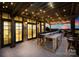 Stylish outdoor patio with bar, grill, and ambient lighting, perfect for entertaining and relaxation at 12613 Oak Grove Rd, Stanfield, NC 28163
