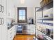 Well-organized pantry with white cabinets, granite countertops, and stainless steel beverage center at 12613 Oak Grove Rd, Stanfield, NC 28163