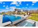 Backyard pool featuring a waterfall feature, patio area, hot tub, and sauna at 12613 Oak Grove Rd, Stanfield, NC 28163