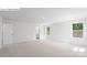 This spacious bedroom is brightly lit from the natural light coming from the two large windows at 1325 Secrest Commons Dr, Monroe, NC 28112