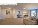 Spacious living room features a comfortable seating area, a functional workspace, and neutral decor at 1325 Secrest Commons Dr, Monroe, NC 28112