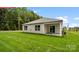 Well-maintained backyard with lush lawn, rear patio, and view of nature at 1344 Secrest Commons Ct, Monroe, NC 28112
