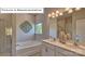 Bright bathroom featuring a soaking tub, double vanity, and modern light fixtures at 1344 Secrest Commons Ct, Monroe, NC 28112