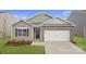 Charming single-Gathering home with brick accents, a two-car garage, and a well-manicured front lawn at 1344 Secrest Commons Ct, Monroe, NC 28112