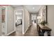 Inviting hallway with hardwood floors, neutral paint, and an open view into the living spaces at 1344 Secrest Commons Ct, Monroe, NC 28112