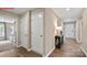 Well-lit hallway with wood floors, access to multiple rooms, and a stylish console table at 1344 Secrest Commons Ct, Monroe, NC 28112