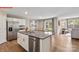 Bright open kitchen with granite island and stainless steel appliances leads to the dining area at 1344 Secrest Commons Ct, Monroe, NC 28112