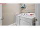 Convenient laundry room equipped with a washer, dryer, and shelving for storage at 1344 Secrest Commons Ct, Monroe, NC 28112