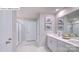 Bright bathroom featuring double vanity, framed mirror, white cabinets, and tiled floor at 1353 Secrest Commons Dr, Monroe, NC 28112
