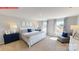 Primary bedroom with large windows, bed, and elegant blue accents at 1353 Secrest Commons Dr, Monroe, NC 28112
