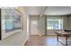 Inviting foyer with hardwood floors, white front door, neutral paint, and lots of natural light from surrounding windows at 1353 Secrest Commons Dr, Monroe, NC 28112