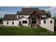 Expansive backyard featuring a covered patio, a two car garage and an expertly manicured lawn at 13820 E Rocky River Rd, Davidson, NC 28036
