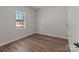 Cozy bedroom with hardwood floors, a large window, and neutral decor at 140 Swimmers Ln, Salisbury, NC 28146