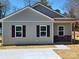 Charming single-story home with gray siding, brown shutters, and a well-manicured lawn at 140 Swimmers Ln, Salisbury, NC 28146