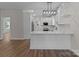 Well-lit kitchen featuring white cabinetry, stainless steel appliances and a breakfast bar for casual dining at 140 Swimmers Ln, Salisbury, NC 28146
