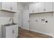 Functional laundry room with ample cabinet space, a utility sink, and laundry hookups at 140 Swimmers Ln, Salisbury, NC 28146