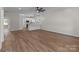 Open-concept living area with modern lighting and hardwood floors seamlessly connected to the stylish kitchen at 140 Swimmers Ln, Salisbury, NC 28146