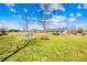 Expansive backyard featuring lush green lawn, mature trees, and an inviting fire pit area at 1429 Scotts Creek Rd, Statesville, NC 28625