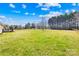 Lush backyard with a large lawn and mature trees with room for outdoor activities at 1429 Scotts Creek Rd, Statesville, NC 28625