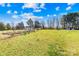 Wide open backyard featuring a garden, lush lawn, and mature trees at 1429 Scotts Creek Rd, Statesville, NC 28625