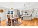 Bright dining area with hardwood floors, modern light fixture, and a view to the outdoor deck at 1429 Scotts Creek Rd, Statesville, NC 28625
