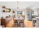 Dining area featuring hardwood floors, stylish lighting, and views of backyard at 1429 Scotts Creek Rd, Statesville, NC 28625