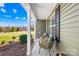 Cozy front porch with wicker seating, offering a relaxing outdoor space with a view of the landscaped yard at 1429 Scotts Creek Rd, Statesville, NC 28625