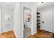 Convenient laundry area featuring modern appliances, built-in shelving, and hardwood flooring at 1429 Scotts Creek Rd, Statesville, NC 28625
