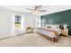 Bright main bedroom featuring carpet, neutral paint, accent wall and a ceiling fan at 1429 Scotts Creek Rd, Statesville, NC 28625