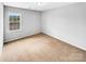Bright bedroom with a large window providing natural light and a view of the neighborhood at 151 Slip Shot Ln, Troutman, NC 28166