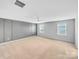 Spacious bedroom featuring modern gray wall, ceiling fan, and plenty of natural light at 151 Slip Shot Ln, Troutman, NC 28166