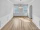 Bright dining room featuring elegant wainscoting, modern chandelier, and ample natural light at 151 Slip Shot Ln, Troutman, NC 28166