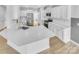 Modern kitchen with white cabinetry, stainless steel appliances, and a spacious island at 151 Slip Shot Ln, Troutman, NC 28166