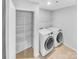 Well-equipped laundry room with washer, dryer, shelving, and ample storage space at 151 Slip Shot Ln, Troutman, NC 28166