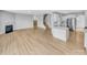 Bright, open living space with a fireplace, kitchen island, and stairs to the upper level at 151 Slip Shot Ln, Troutman, NC 28166