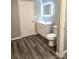 A modern bathroom featuring a new vanity, sleek illuminated mirror, and new toilet at 1607 W Nc 27 Hwy, Lincolnton, NC 28092