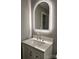 A vanity features an illuminated arched mirror, creating a serene and modern bathroom at 1607 W Nc 27 Hwy, Lincolnton, NC 28092